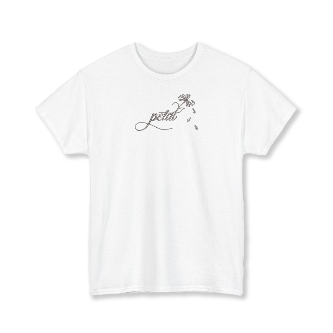 White t-shirt with dark grey embroidered “petal” calligraphy design extending into a daisy stem