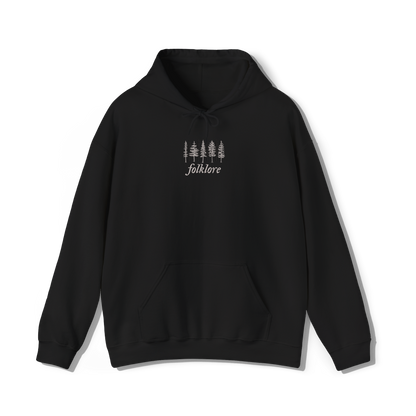 taylor swifts folklore album title embroidered alongside some trees on a black coloured hoodie