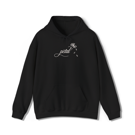 Black hoodie featuring white embroidered cursive “petal” design with a delicate daisy stem and scattered petals