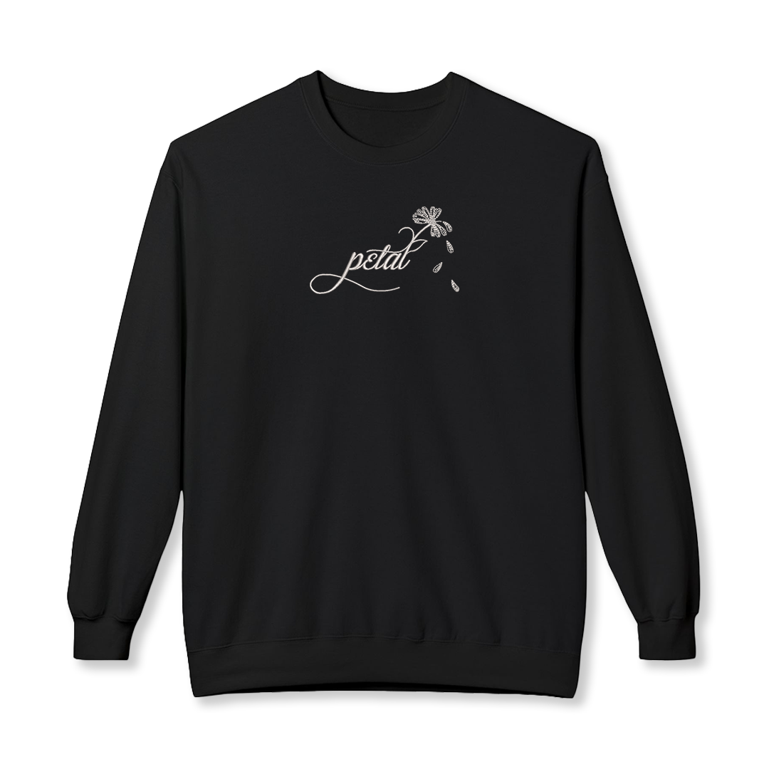 Black sweatshirt featuring white embroidered cursive “petal” design with daisy stem and scattered petals