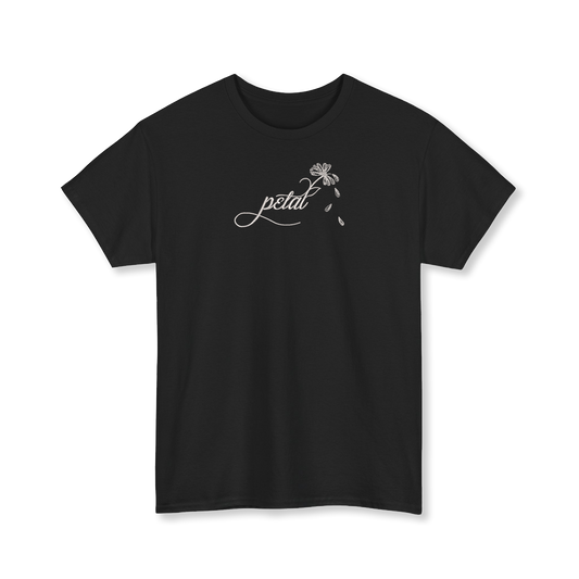 Black t-shirt featuring white embroidered cursive “petal” design with daisy stem and scattered petals