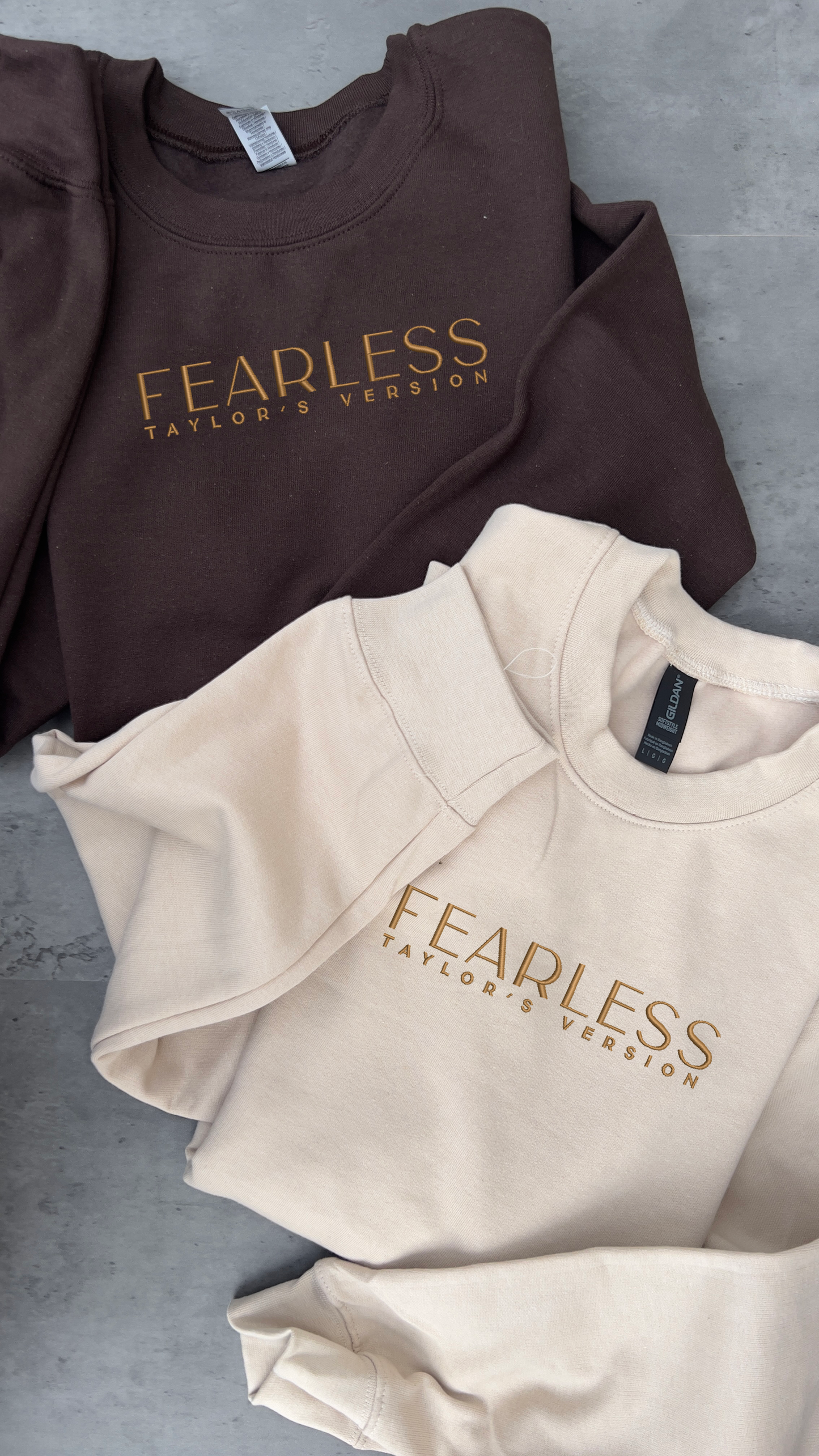 taylor swifts fearless album title embroidered on a dark brown and sand hoodie