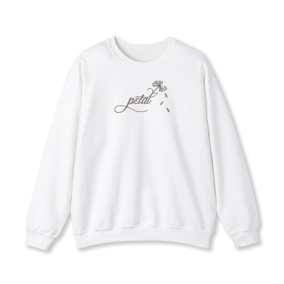 White sweatshirt with dark grey embroidered “petal” calligraphy design extending into a daisy stem